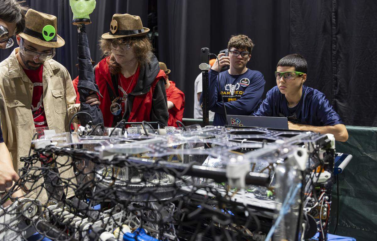 Coral Park Senior High School student Erick Fernandez, 15, far right, a member of Ram Tech, waits alongside his team’s robot, Rico, as they prepare to compete in the 2026 FIRST Robotics South Florida Regional Competition at the University of Miami’s Watsco Center on Friday, April 10, 2026, in Coral Gables, Fla. Participants from local school districts, surrounding states, and international teams are competing for an opportunity to earn a spot at the 2026 FIRST World Championship.