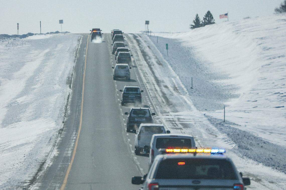 A motorcade climbs a hill on US-65 with former President Donald Trump on Sunday, Jan 14, 2023, while en route to Simpson College in Indianola, IA, where he spoke at a rally to lock down undecided Iowans before Monday’s caucuses.