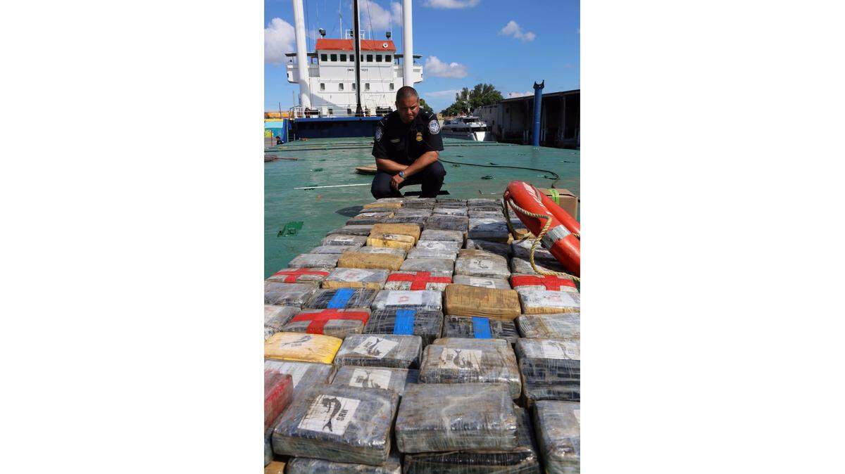 Dylan J. DeFrancisci, port director for U.S. Customs and Border Protection, is shown with 2,000 pounds of cocaine that was hidden on a Haitian freighter on the Miami River, the biggest drug bust in more than a decade, on Wednesday, June 1, 2016.