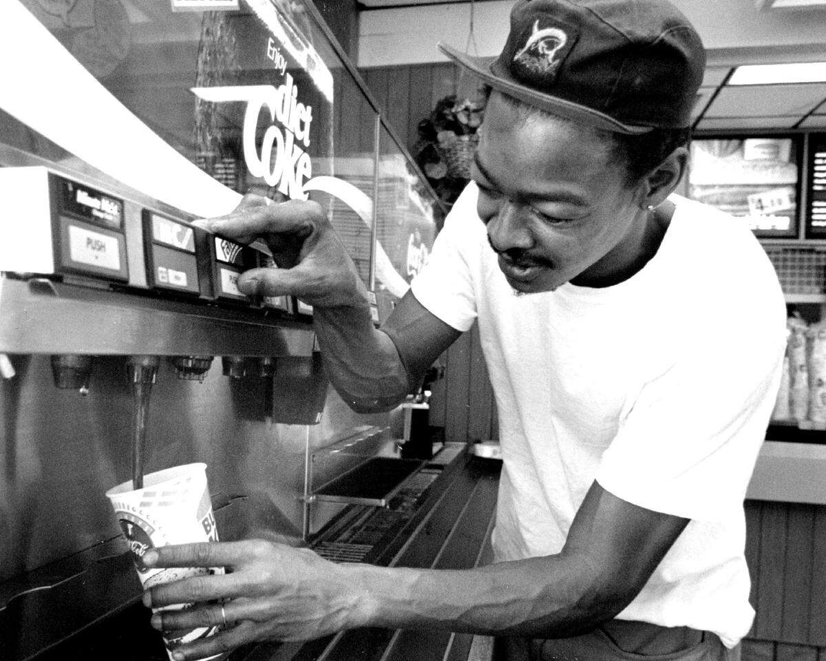 A customer dispenses a strawberry soda at Burger King in 1995.