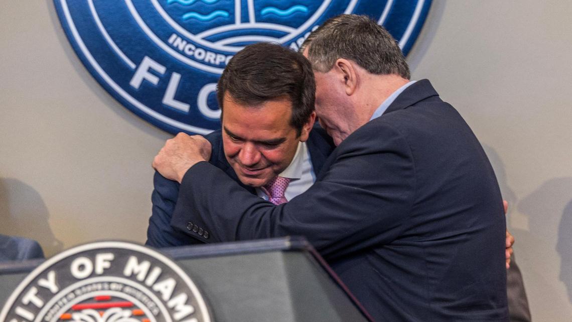 Miami Commissioner Joe Carollo, right, leans in to speak to newly elected City Commissioner Ralph Rosado during Rosado’s swearing-in ceremony at City Hall on Tuesday, June 10, 2025.