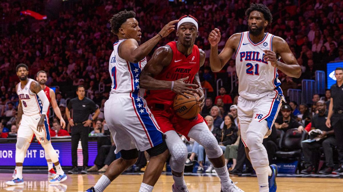 Miami Heat forward Jimmy Butler (22) looks to shoot while defended by Philadelphia 76ers guard Kyle Lowry (7) and center Joel Embiid (21) during the first half of an NBA game at the Kaseya Center on Monday, Nov. 18, 2024, in Miami, Fla.