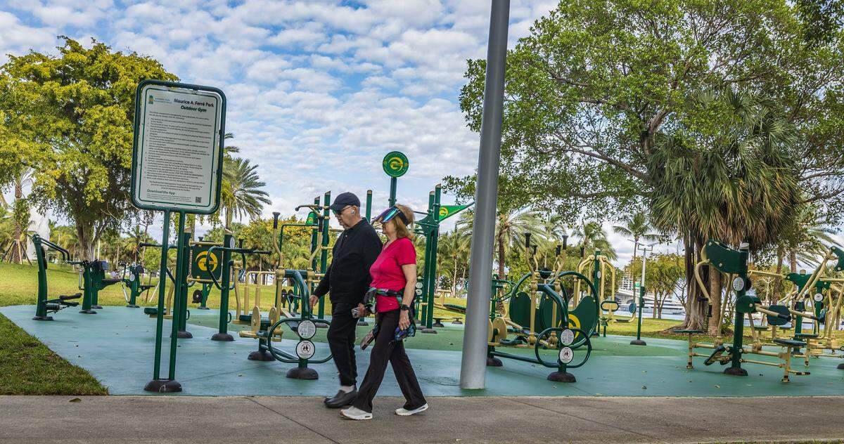 A couple walk by the outdoor gym equipment in Maurice A. Ferré Park, one of the projects of former City of Miami Commissioner Joe Carollo's legacy being scrubbed from the city, in Miami, on Thursday, January 29, 2026.