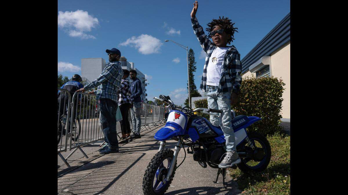 Kenton Grant, 5, stands on his 50cc motorcycle as he waves to members of the Miami Police bike patrol and others during the 45th Annual Martin Luther King Jr. Parade on Monday, Jan. 17, in Miami. The sun was shining, but temperatures were a bit cool, with a high of 75 but a low of 56, according to the National Weather Service’s Monday forecast.
