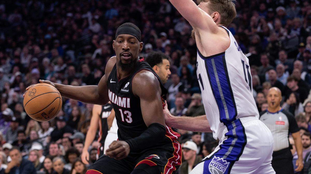 Miami Heat center Bam Adebayo (13) drives to the basket against Sacramento Kings forward Domantas Sabonis (11) during the second quarter at Golden 1 Center.