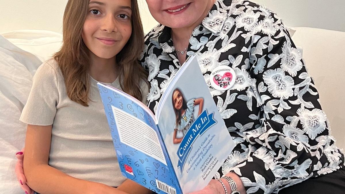 Ruth Gordon and her granddaughter, Lennox, look at ‘Count Me In,’ a book Gordon wrote about the math learning disorder called ‘dyscalculia.’