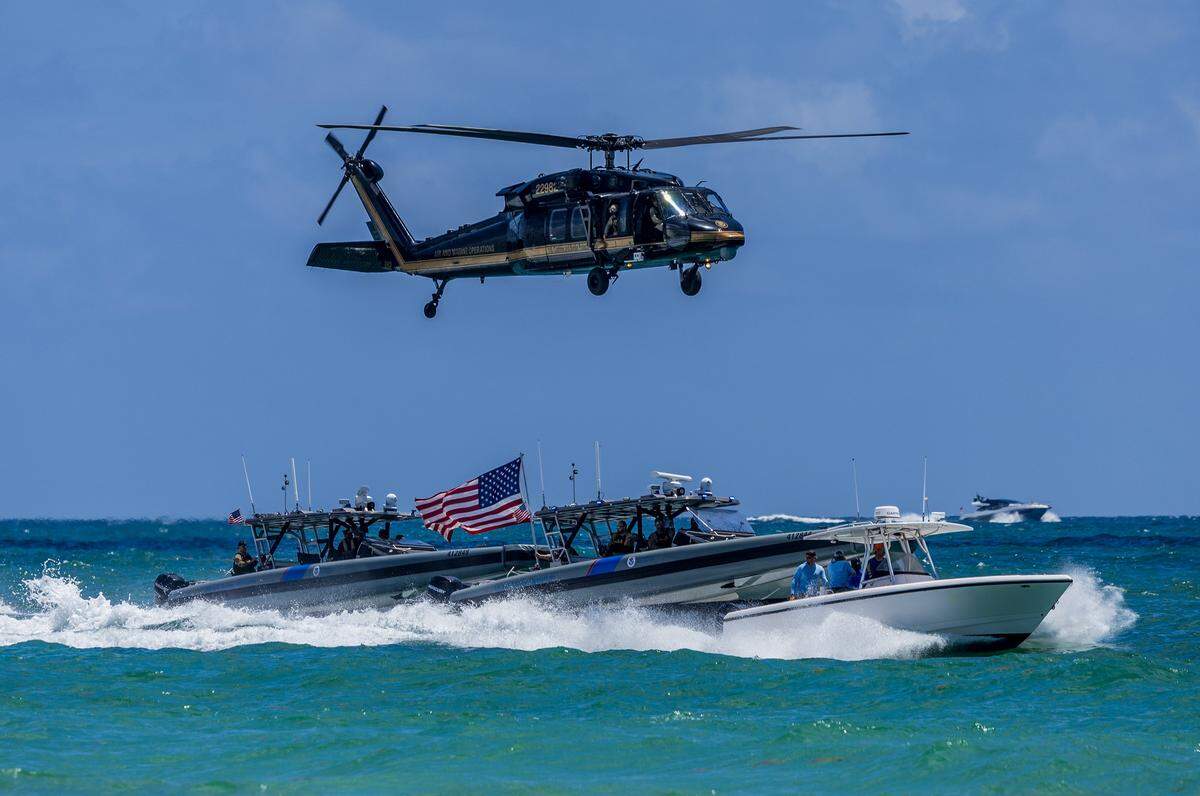 Vessels and a helicopter from the U.S. Customs and Border Patrol perform an interdiction demonstration in South Beach during the Hyundai Air & Sea Show annual National returns Salute to America's Heroes for Memorial Day Weekend celebration, in Miami Beach, on Saturday, May 23, 2026.
