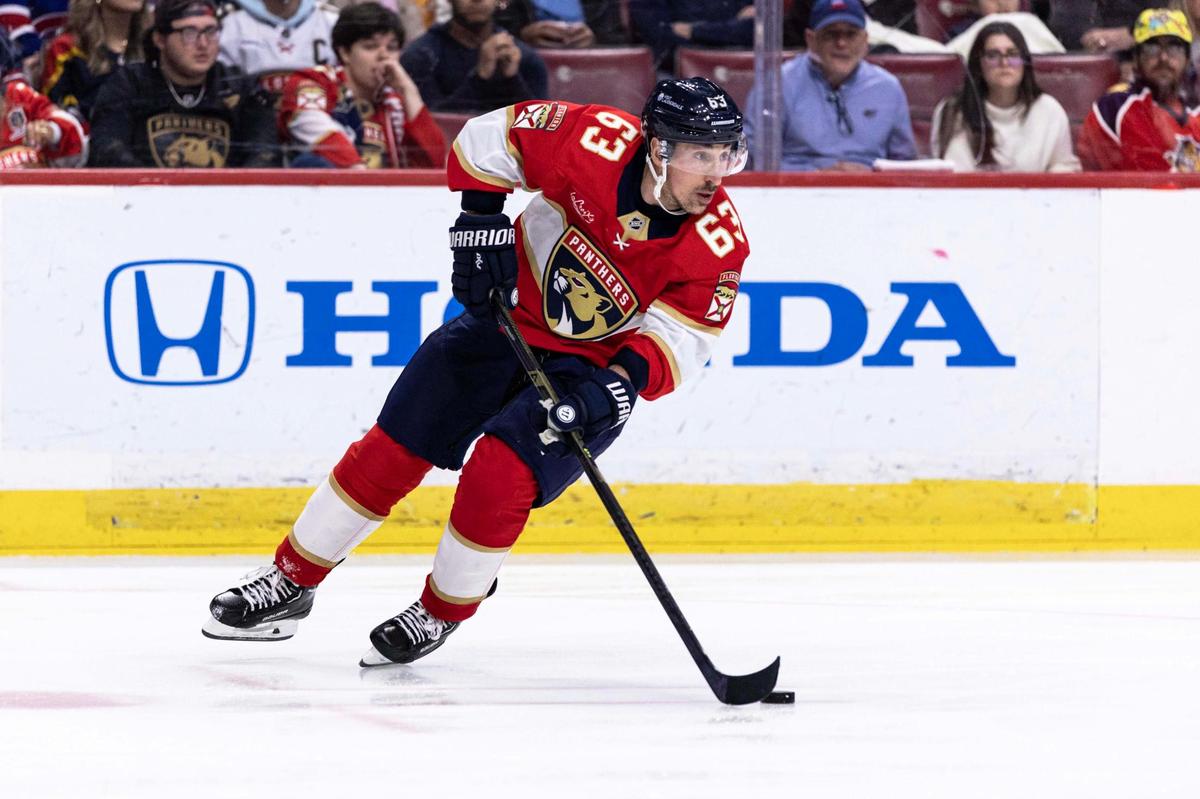 Florida Panthers center Brad Marchand (63) controls the puck as he looks down the ice to pass during the second period of an NHL game against the Montreal Canadiens at Amerant Bank Arena on Sunday, March 30, 2025, in Sunrise, Fla.