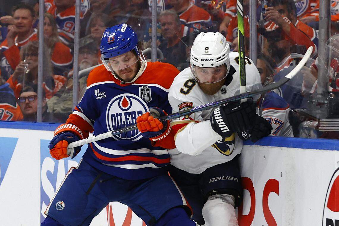 Jun 4, 2025; Edmonton, Alberta, CAN;Edmonton Oilers center Mattias Janmark (13) checks Florida Panthers center Sam Bennett (9) in the second period in game one of the 2025 Stanley Cup Final at Rogers Place.