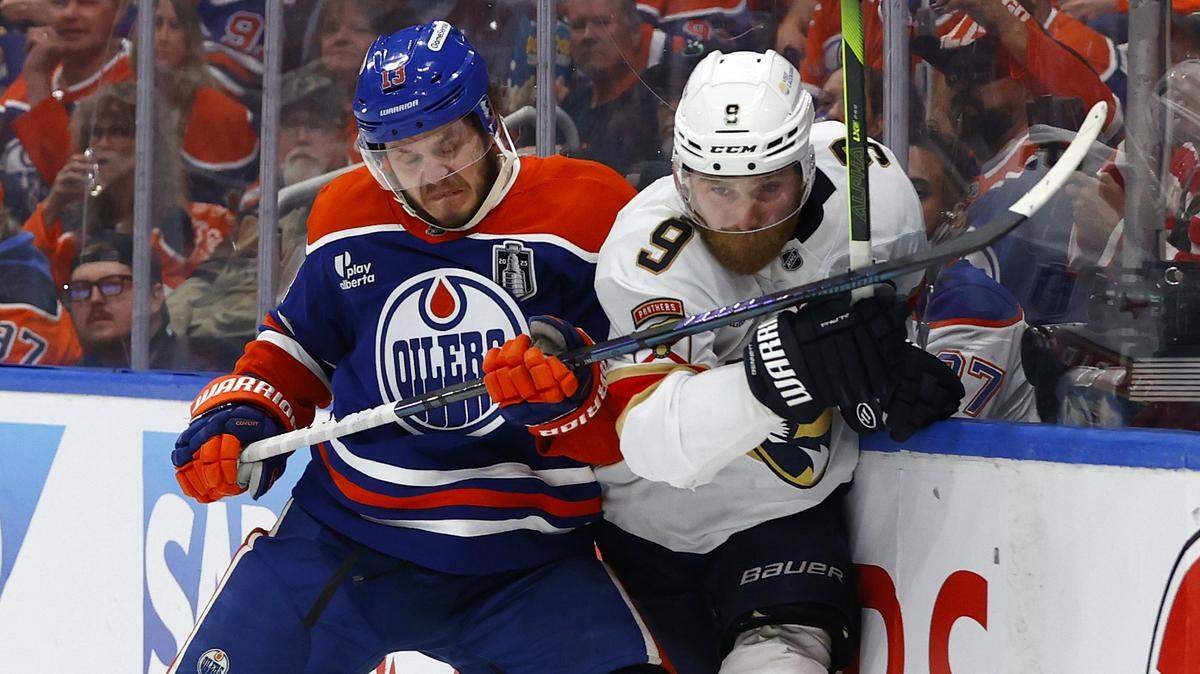 Jun 4, 2025; Edmonton, Alberta, CAN;Edmonton Oilers center Mattias Janmark (13) checks Florida Panthers center Sam Bennett (9) in the second period in game one of the 2025 Stanley Cup Final at Rogers Place. Mandatory Credit: Perry Nelson-Imagn Images