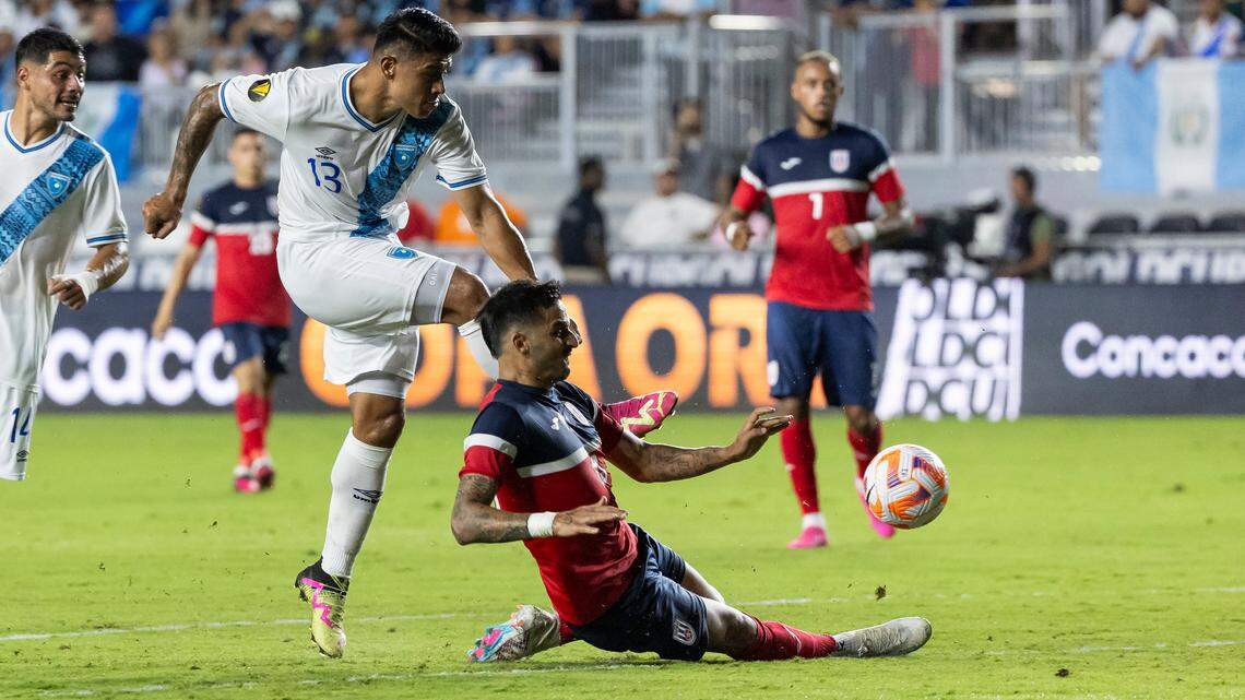 Cuba defender Jorge Corrales (13) slide tackles to stop a shot by Guatemala midfielder Alejandro Galindo (13) in the first half of their CONCACAF Gold Cup 2023 match at DRV PNK Stadium on Tuesday, June 27, 2023, in Fort Lauderdale, Fla.