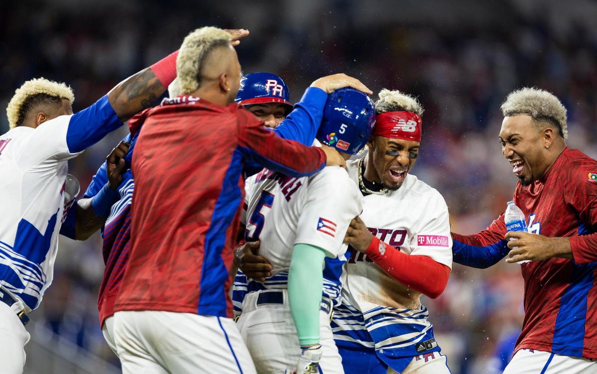 Puerto Rico center fielder Enrique Hernández (5) celebrates with his teammates after defeating Israel 10 to 0 during their Pool D game at the World Baseball Classic at loanDepot Park on Monday, March 13, 2023, in Miami, Fla.