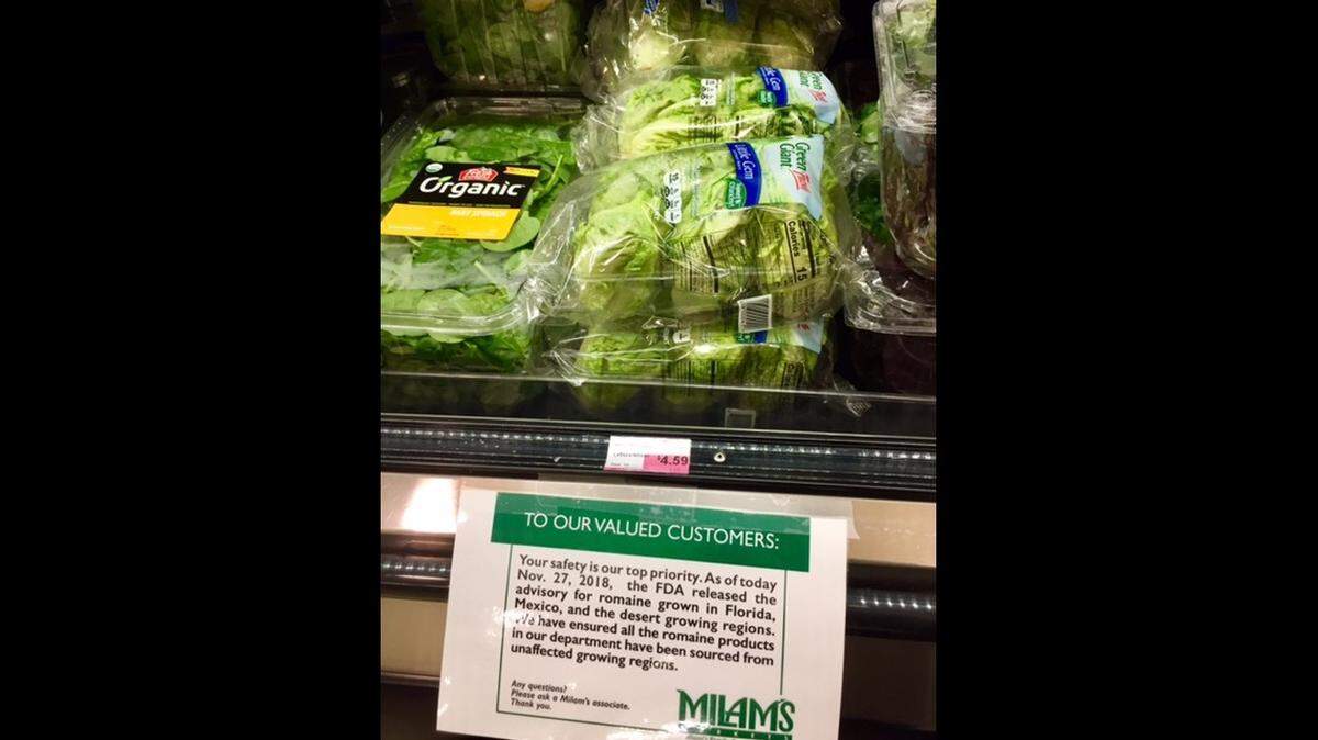 A produce section advisory at Milam’s Market alerts customers to the end of the recall of romaine lettuce harvested from safe regions.