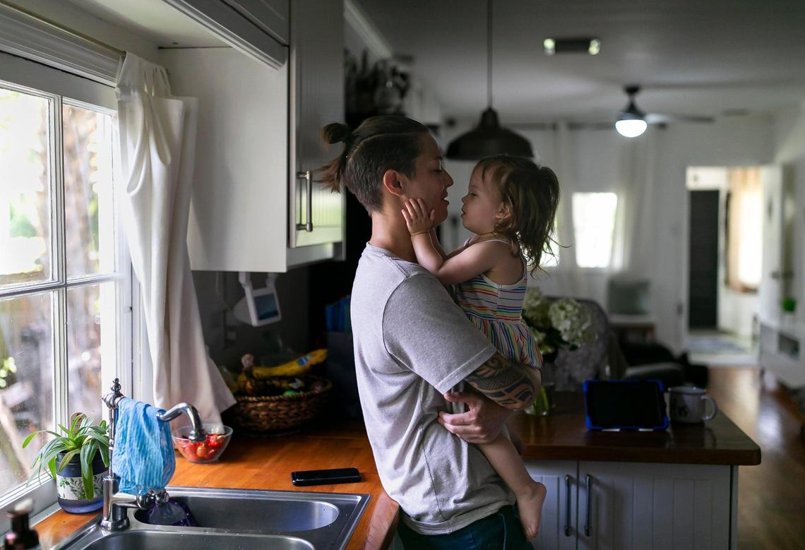 Broward Sheriff’s Office Battalion Chief Nichole Notte, 41, kisses her daughter, Luca, 1, at their home on Tuesday, June 21, 2022 in Fort Lauderdale, Fla. Notte, who was a first responder during the Champlain Towers South condo collapse in Surfside, has been dealing with post traumatic stress disorder and anxiety.