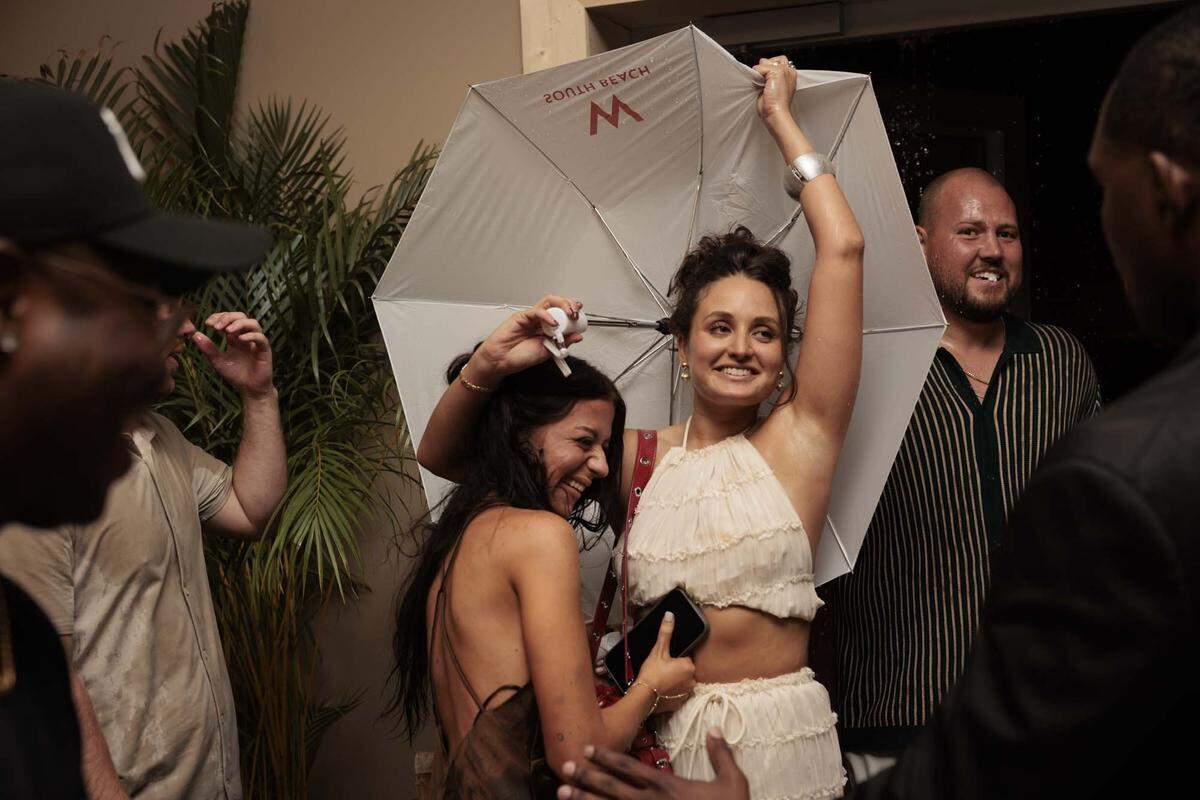 People come in from the storm before the Hot Girl Summer PARAISO Miami Swim Week Runway Show on Thursday, May 28, 2026, on Collins Ave. in Miami Beach, Fla. (Miami Herald photojournalists were restricted from covering the actual runway show).