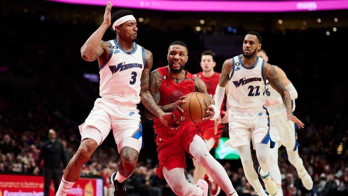 Portland Trail Blazers guard Damian Lillard (0) drives to the basket during the second half against Washington Wizards guard Bradley Beal (3) at Moda Center.