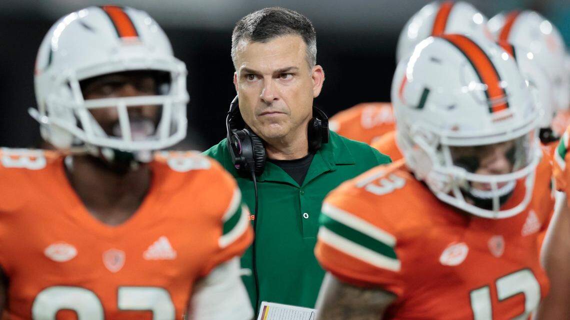 Miami Hurricanes head coach Mario Cristobal walks with players during a timeout in the game against Florida State Seminoles at Hard Rock Stadium in Miami Gardens on Saturday, November 5, 2022.
