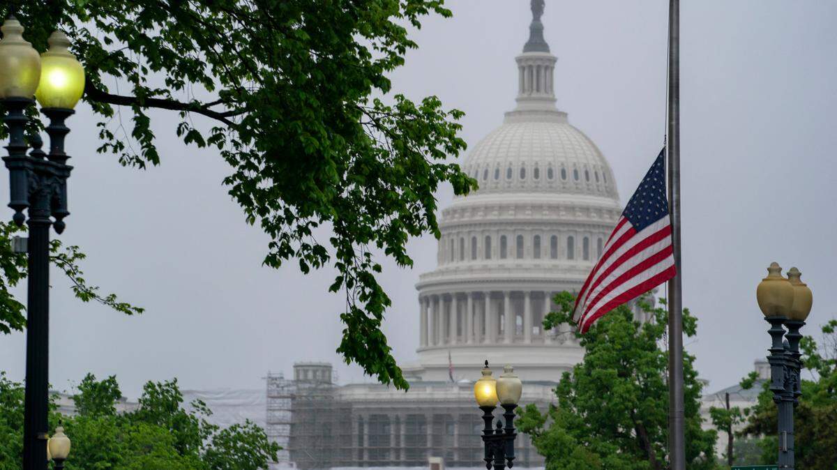 The American flag is seen at half-staff with the Capitol in the distance, in Washington, Friday, May 13, 2022. President Joe Biden ordered the flags lowered on all Federal buildings to honor the nearly 1 million deaths in America due to the COVID-19 outbreak. (AP Photo/J. Scott Applewhite)