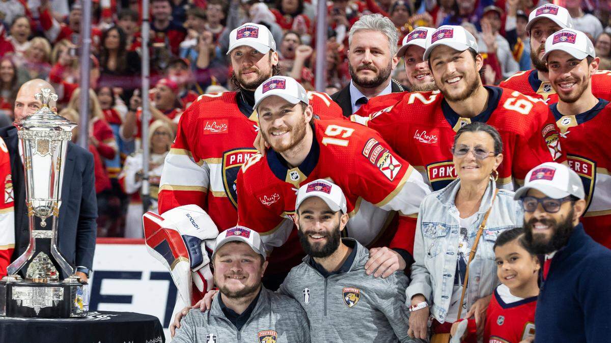 Florida Panthers left wing Matthew Tkachuk (19), defenseman Brandon Montour (62), goaltender Sergei Bobrovsky (72), center Evan Rodrigues (17), team staff and other teammates gather for a photo with Bill Daly (not pictured), deputy commissioner of the NHL, and the Prince of Wales trophy after defeating the New York Rangers in Game 6 of the Eastern Conference finals of the NHL hockey Stanley Cup playoffs at the Amerant Bank Arena on Saturday, June 1, 2024, in Sunrise, Fla.