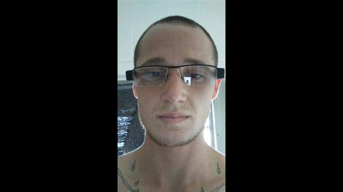 Scott Whitney demonstrates the oversize eyeglasses that were fitted with a camera lens.