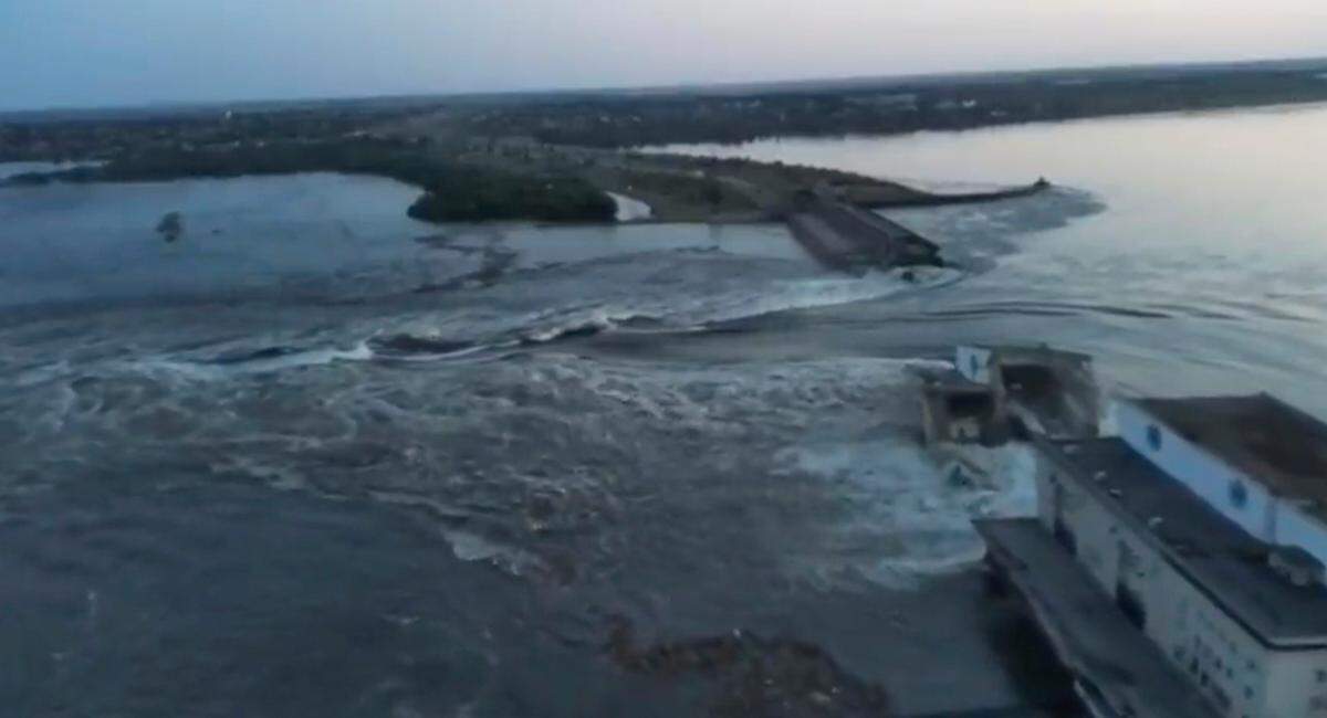 Water rushes through a breach in the Kakhovka Dam in a Russia-controlled area of southern Ukraine on Tuesday, June 6.