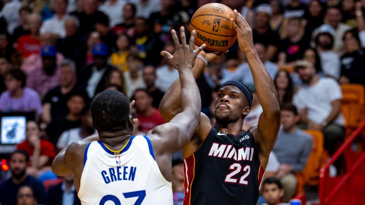 Miami Heat forward Jimmy Butler (22) shoots the ball over Golden State Warriors forward Draymond Green (23) during the first half of an NBA game at FTX Arena in Downtown Miami, Florida, on Tuesday, November 1, 2022.