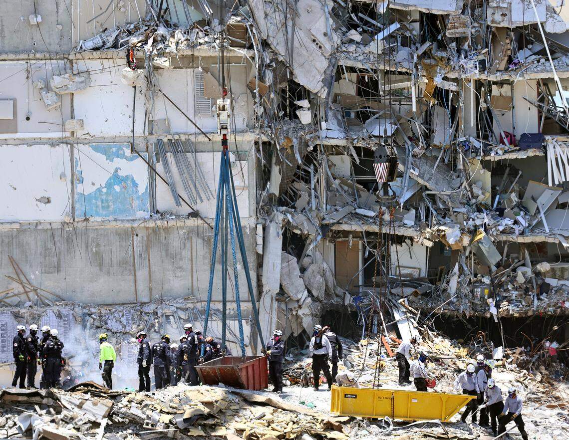 Search and rescue personnel search for survivors through the rubble at the Champlain Towers South Condo in Surfside, Florida, Sunday, June 27, 2021. The apartment building partially collapsed on Thursday, June 24.