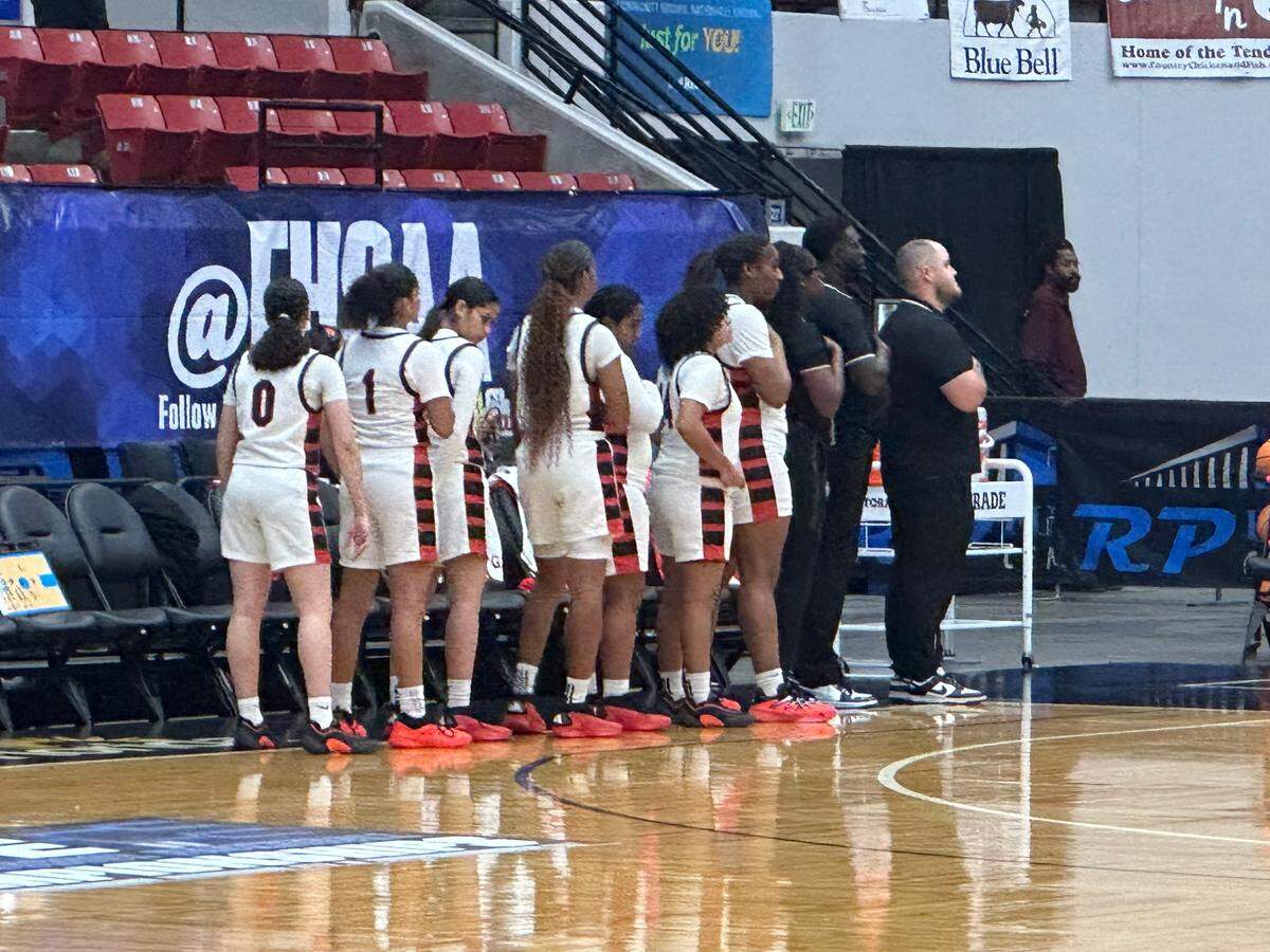 Southridge players and coaches listen to the national anthem just prior to Thursday’s Class 6A state girls’ basketball semifinal against Lutz Steinbrenner at the RP Funding Center in Lakeland, Fla.