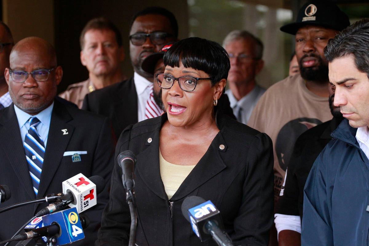 Miami-Dade County Commission Chairwoman Audrey M. Edmonson, center, joined by other community leaders and law enforcement, gives her remarks as she hosted the annual press conference “One Bullet Kills the Party” on Monday, Dec. 30, 2019, at Olinda Park in Miami, Florida.