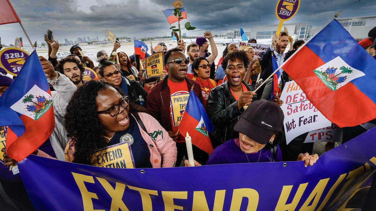 Protesters gather during a candlelight vigil, and interfaith prayer at Fort Lauderdale–Hollywood International Airport as airport workers and faith leaders rally calling on the Trump Administration to extend Temporary Protected Status (TPS) for Haiti on Jan. 28, 2026. 
