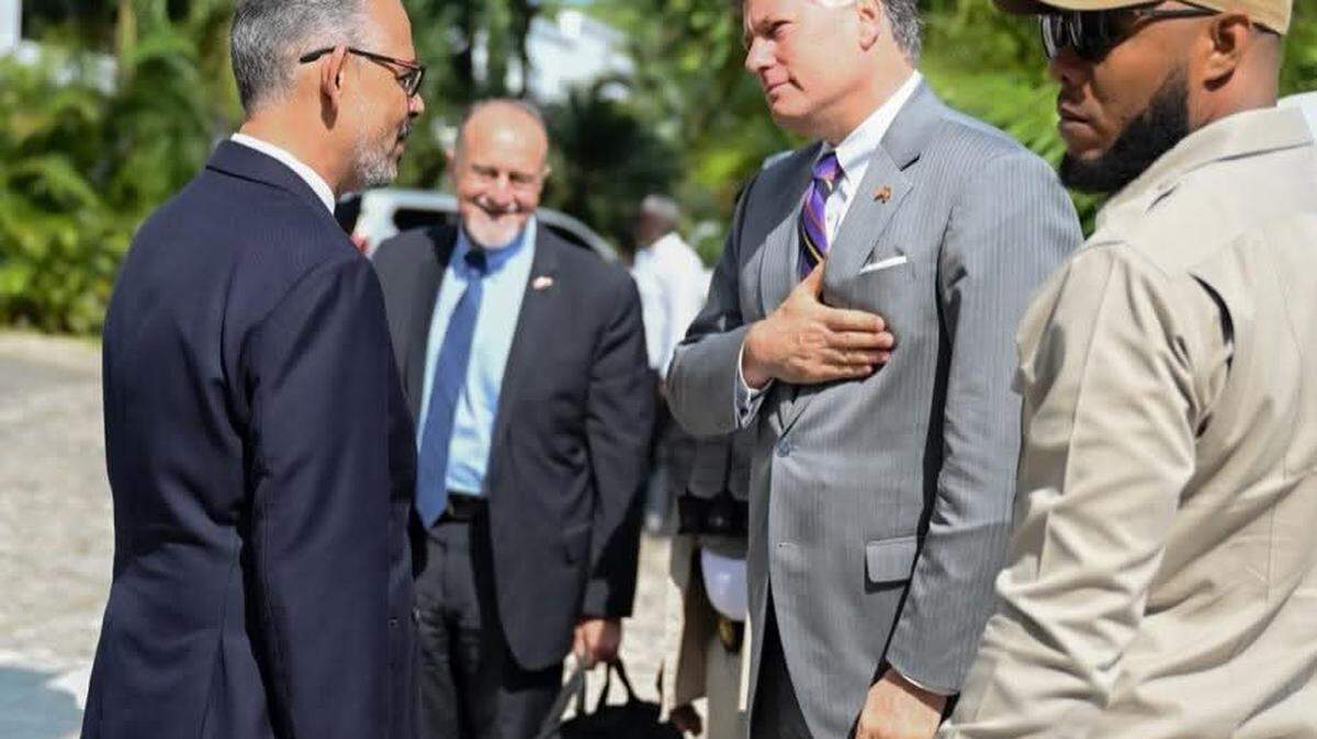 Haiti Prime Minister Alix Didier Fils-Aimé, left, speaks with U.S. Deputy Secretary of State Christopher Landau in Port-au-Prince on Friday, May 29, 2026. In the foreground is the U.S. chargé d’affaires in Haiti, Henry T. Wooster.