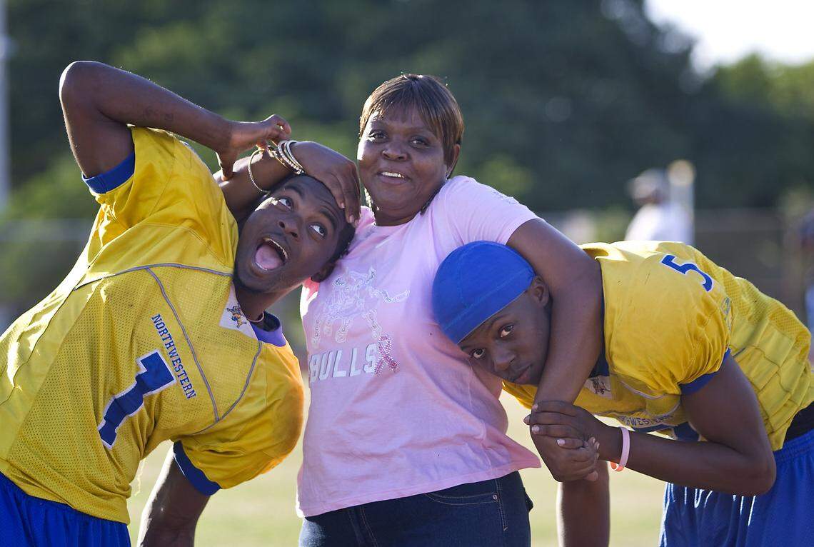 L-R Northwestern High School football stars Eli Rogers and Teddy Bridgewater flank Teddy’s mom Rose Murphy on Wednesday November 24, 2010 outside the school.