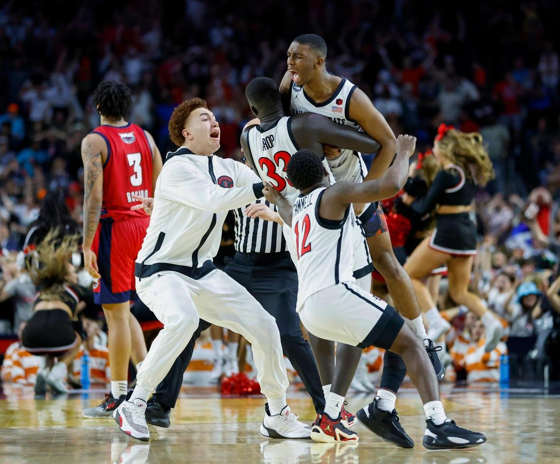 San Diego State Aztecs guard Lamont Butler (5) celebrate with teammates after hitting the winning shot over Florida Atlantic Owls guard Nicholas Boyd (2) during the second half of the Men’s Basketball Championship National Semifinal at NRG Stadium in Houston, Texas on Saturday, April 1, 2023.