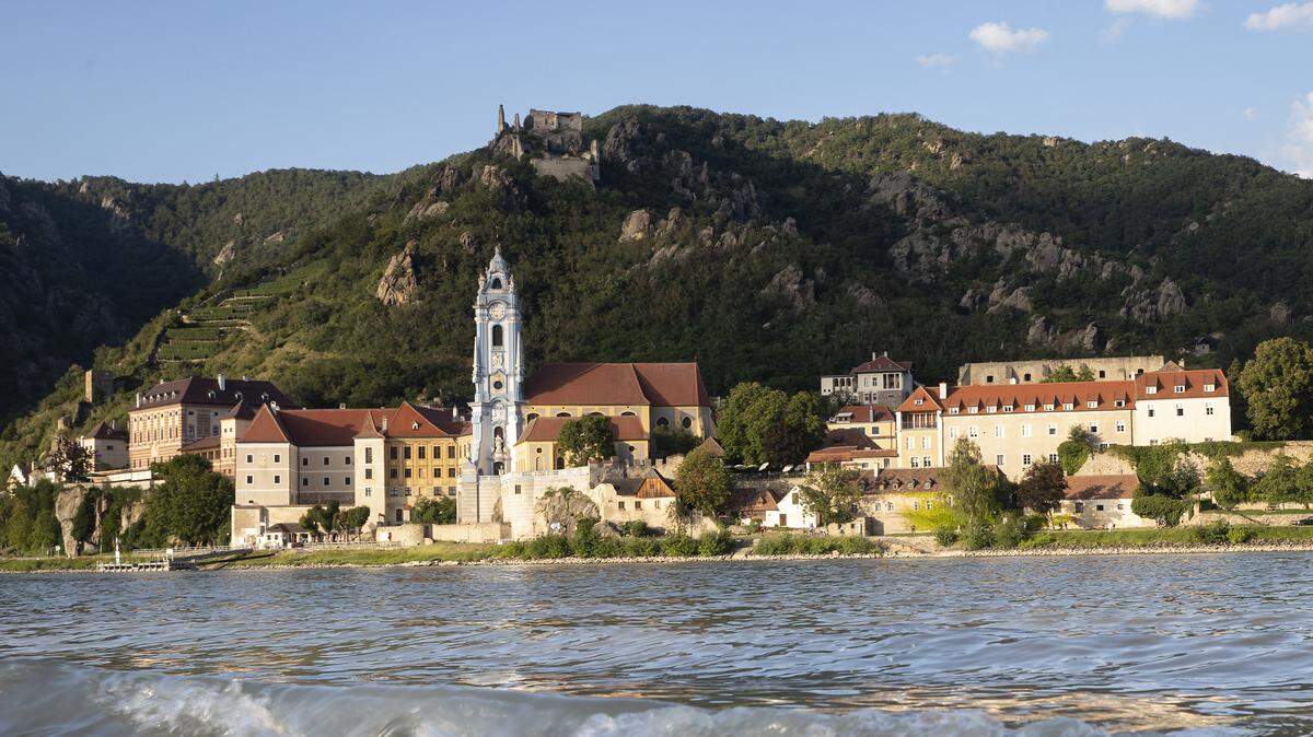 Place Durnstein with the blue tower of the former Augustinian Canonry in the Wachau World Heritage region, 80 km west of Vienna, Lower Austria, Austria is seen on August 10, 2024 from other banks of the Danube, as it is considered a landmark of the Wachau region.