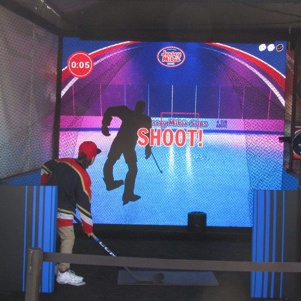 A fan at the Jersey Mike’s slapshot booth during the Enterprise NHL Winter Classic Pregame Fanfest outside loanDepot Park.