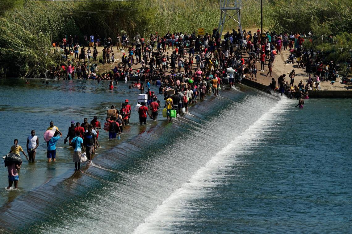 Haitian migrants used a dam to cross to and from the United States from Mexico on Sept. 17, 2021, in Del Rio, Texas. Thousands of Haitian migrants assembled under and around a bridge in Del Rio presenting the Biden administration with a fresh and immediate challenge as it tried to manage large numbers of asylum-seekers who had been reaching U.S. soil.