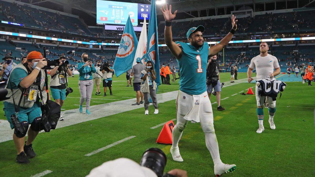 Miami Dolphins quarterback Tua Tagovailoa (1) walks off the field in celebration after defeating the New England Patriots at Hard Rock Stadium in Miami Gardens on Sunday, January 9, 2022.