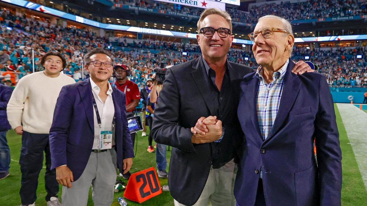 Miami Dolphins Vice President, President & CEO Tom Garfinkel, and Owner Stephen Ross, celebrate as they come off the field after the Dolphins defeat the San Francisco 49ers in their NFL football game at Hard Rock Stadium in Miami Gardens, Florida, on Sunday, December 22, 2024. At left is Joe Tsai, already an investor in the NBA, WNBA, MLS and two pro lacrosse leagues, is now part owner of the NFL’s Miami Dolphins.