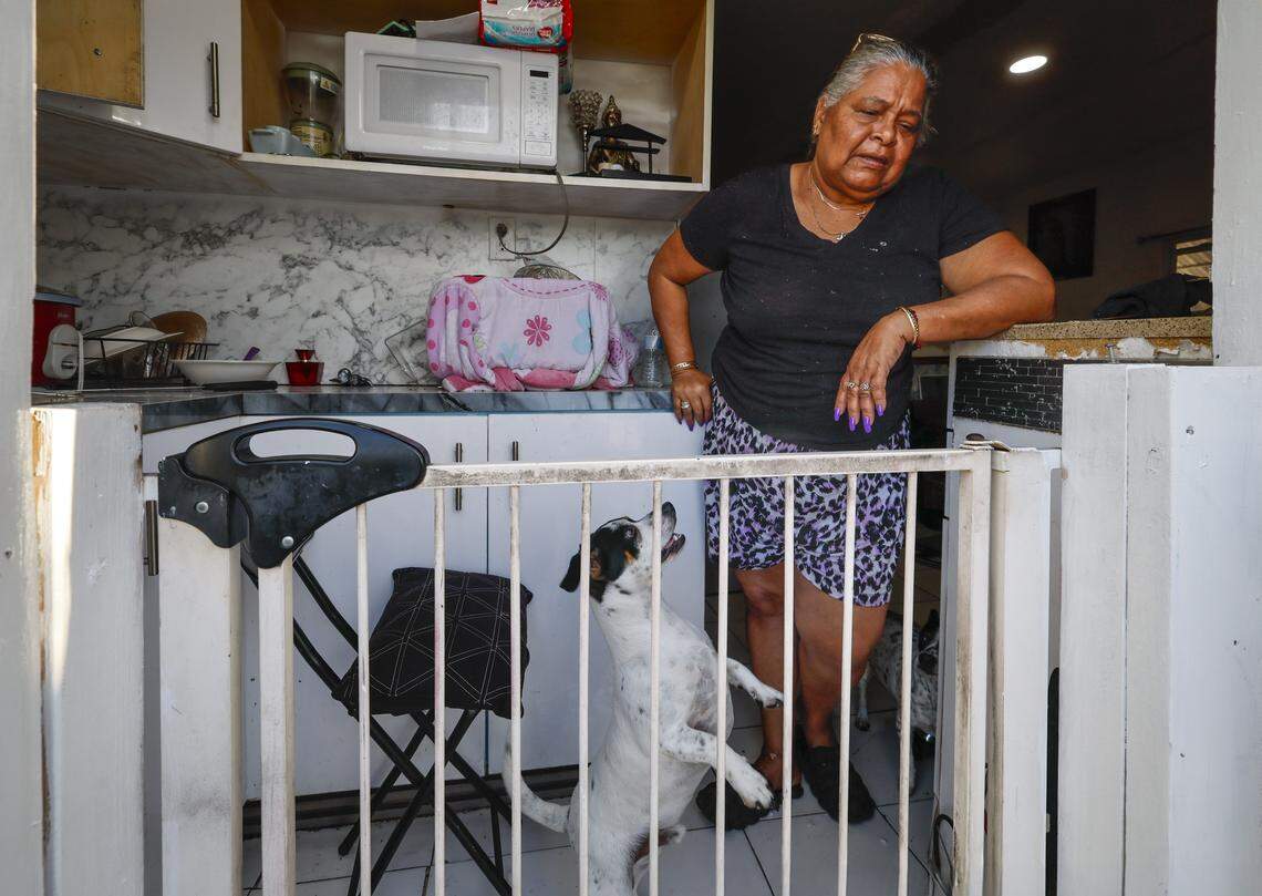 Marilyn Hernandez, 62, stands inside her home with her dog Sammy at Silver Court Mobile Home Park in Miami, Florida, on Friday, April 17, 2026. 