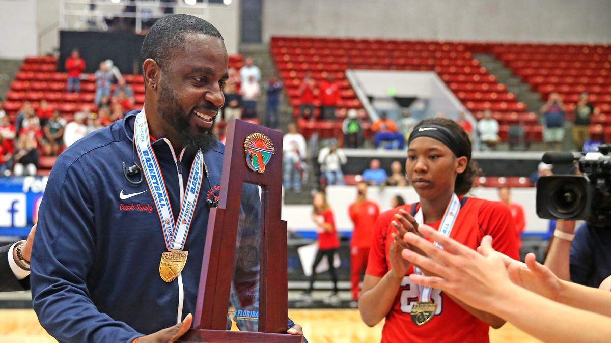 Miami Country Day coach Ochiel Swaby holds the trophy after they defeated Carrollwood Day in the 4A Finals Girl’s State Basketball Championships at the RP Funding Center in Lakeland, Florida, Thursday, February, 28, 2019.