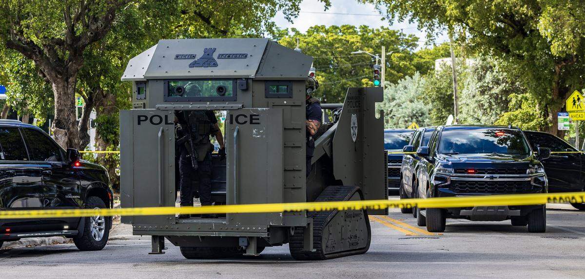 A police armored vehicle is on the scene where two Miami police officers were shot Thursday morning, Oct. 9, 2025, in Miami’s Allapattah neighborhood. One man is in police custody and an armed man is barricaded inside a house in the area, police said..