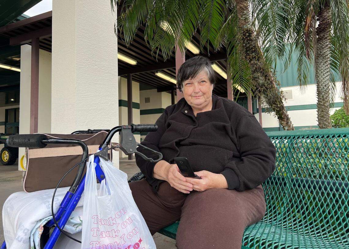 Kathy Lorenz on a bench outside the Red Cross shelter set up at Arcadia’s Civic Center. The city’s shelter has since closed.