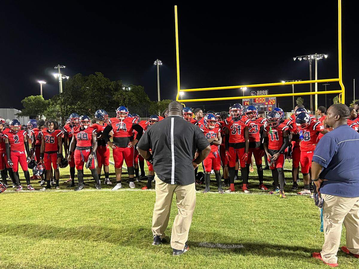 Miramar coach AJ Scott talks to his team after the Patriots lost 20-14 to Highland Springs (Va.) on Friday in the Broward Showcase.