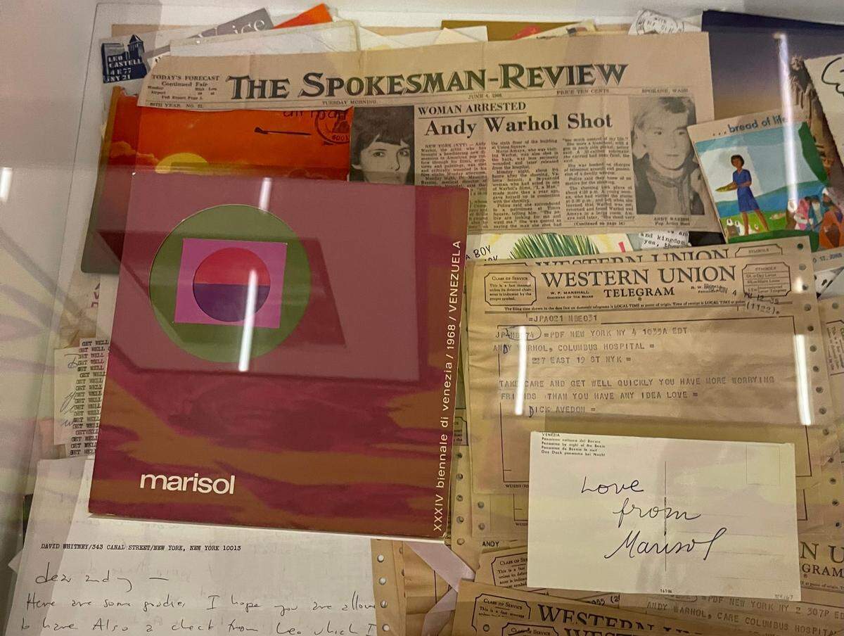 Andy Warhol kept a catalog of Marisol’s exhibition at the 1968 Venice Biennale and a postcard from Marisol in his cardboard box “time capsule.”