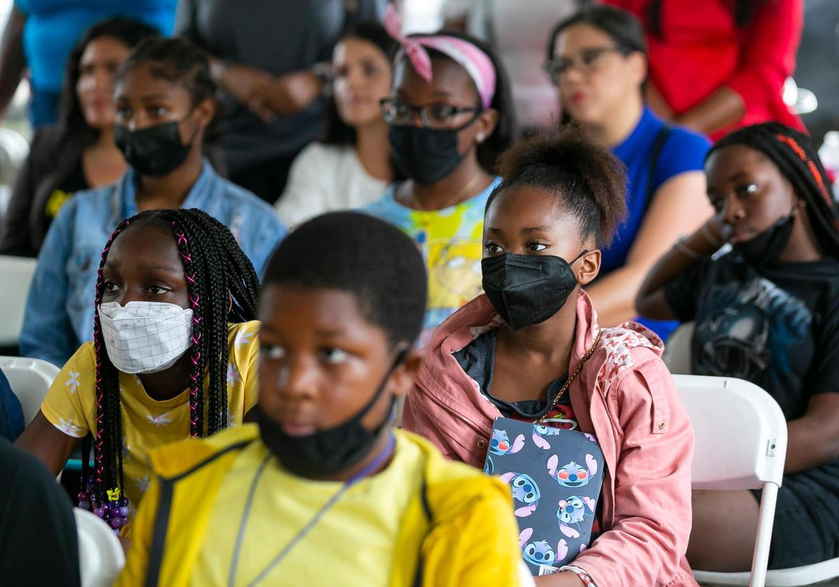 Fourth-grader Zahara Cunningham, to the right in the pink jacket and a member of the United Community Options’ Diamond Minds, listens to a press conference hosted by The Children’s Trust at the Opa-locka Community Development Corporation Alice Brown Apartments on Tuesday, June 14, 2022, in Opa-locka. The Children’s Trust announced its board approved a $14 million investment to help South Florida families struggling with high housing costs and COVID-related expenses.