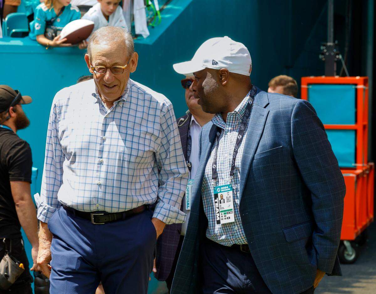  Miami Dolphins owner Stephen Ross, left, and  Miami Dolphins general manager Chris Grier, right, on the field  before the start of the game against the Jacksonville Jaguar s at Hard Rock Stadium.