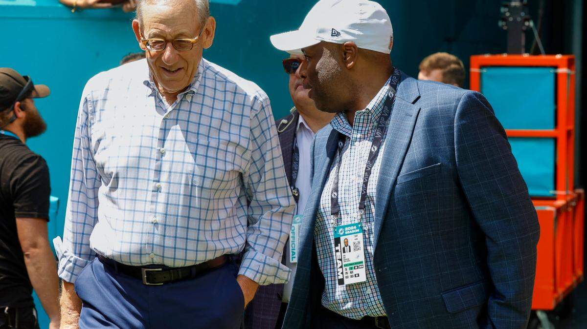 Miami Dolphins owner Stephen Ross, left, and Miami Dolphins general manager Chris Grier, right, on the field before the start of the game against the Jacksonville Jaguar s at Hard Rock Stadium.