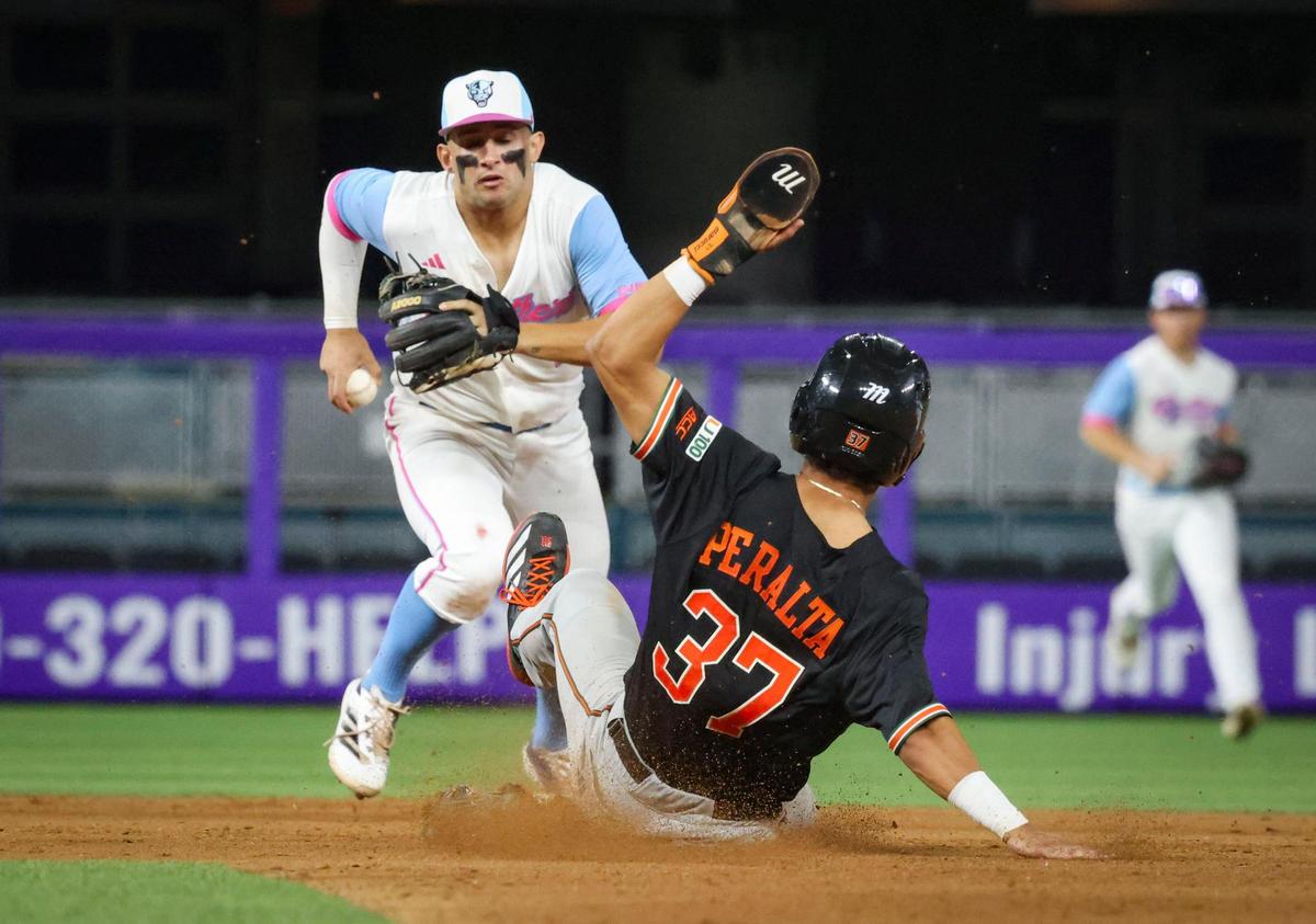 FIU infielder Alex Ulloa (1) attempts to tags second base to get Miami outfielder Fabio Peralta (37) out during the sixth inning of a game on Tuesday, March 4, 2025, at loanDepot Park in Miami, Fla. The Hurricanes won.