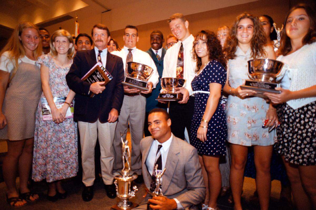 Some of the winners gather around Michael Irvin at the 1995 All-Broward Athletic Awards Ceremony at the Broward County Convention Center.
