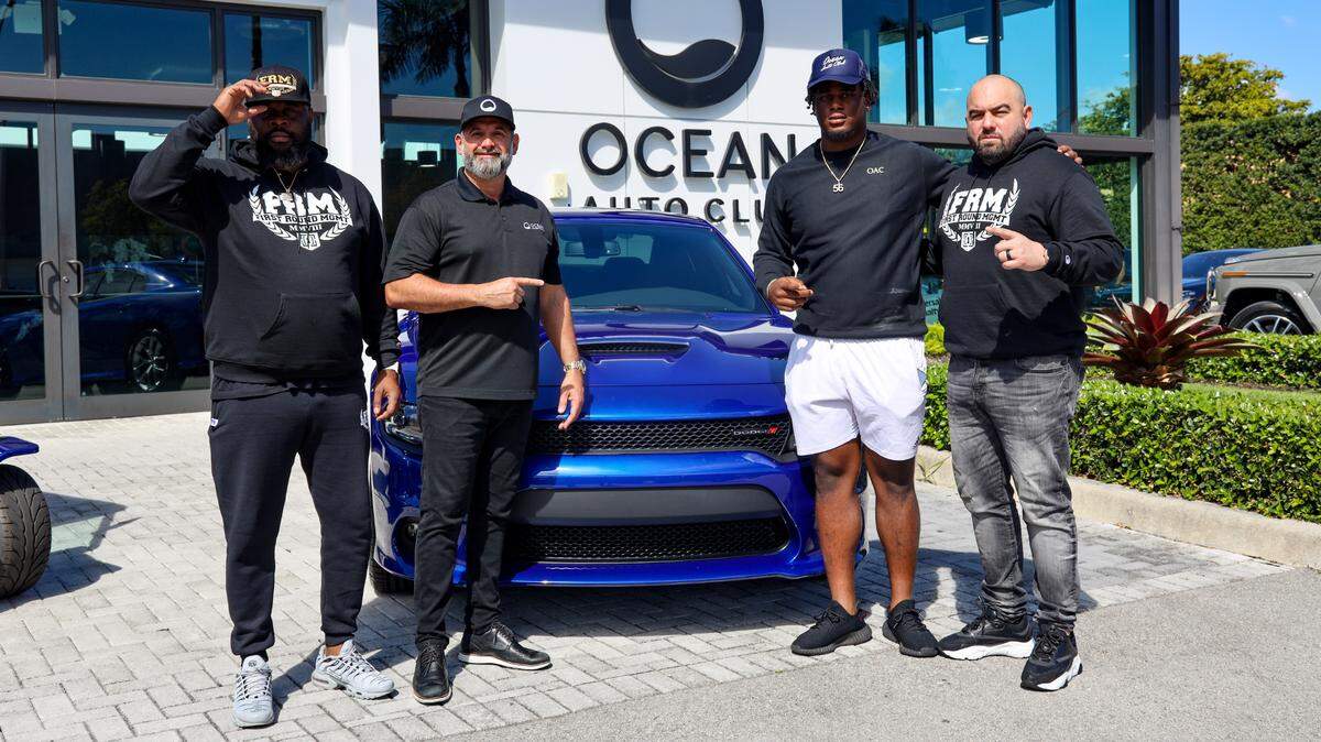 First Round Management agent J.R. Bryant (from left), Ocean Mazda Doral general manager Fernando Rodriguez, Miami Hurricanes defensive tackle Leonard Taylor and First Round Management agent Malki Kawa.